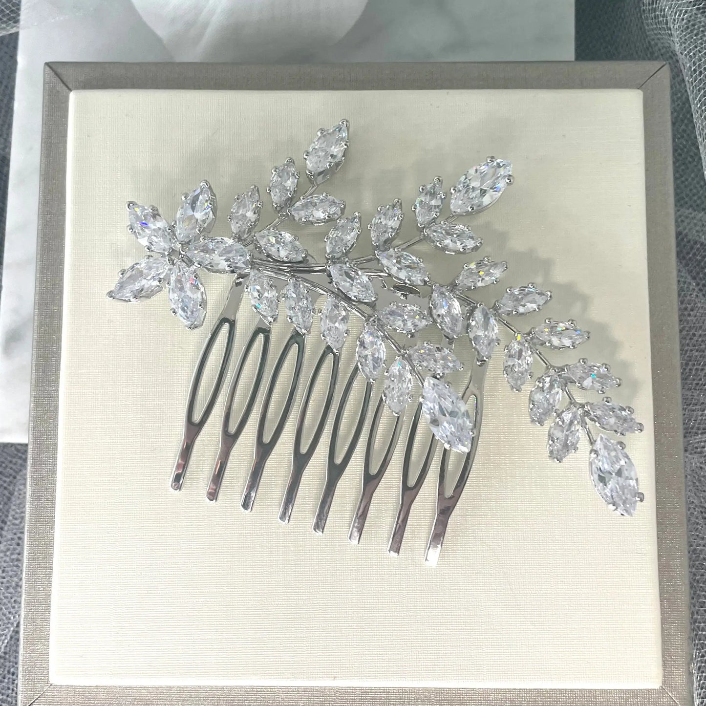 Sophisticated Ross Leaf Bridal Hair Comb in silver, adorned with sparkling marquise crystals, perfect for adding a contemporary and elegant touch to bridal hairstyles.