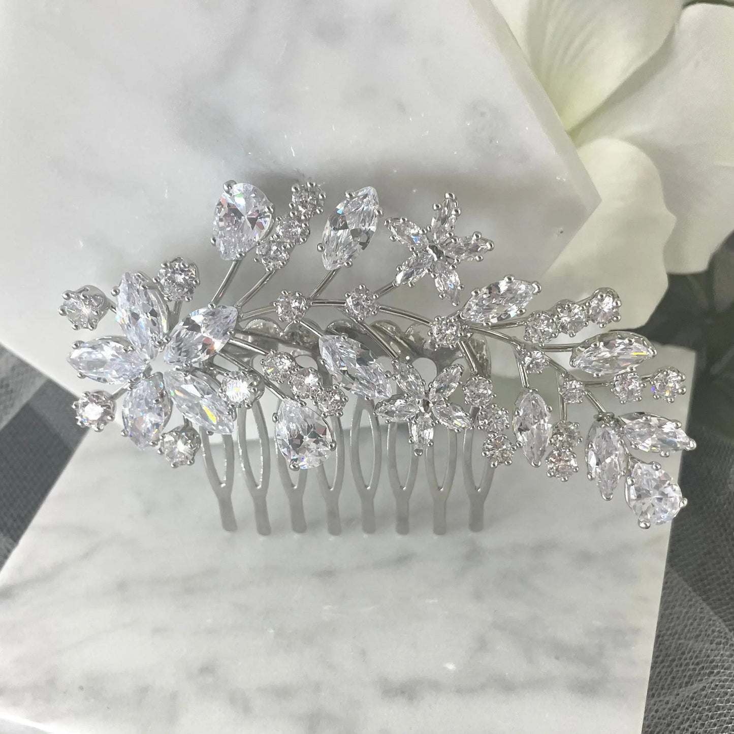 Exquisite Sally Bridal Wedding Hair Comb in silver, featuring detailed leaves, flowers, and crystal clusters, ideal for adding a sophisticated sparkle to bridal hairstyles.
