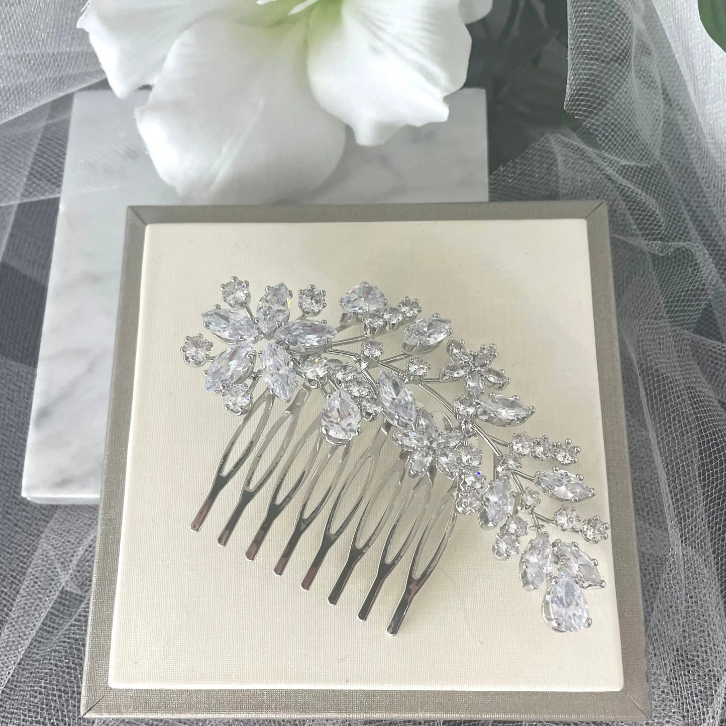 Exquisite Sally Bridal Wedding Hair Comb in silver, featuring detailed leaves, flowers, and crystal clusters, ideal for adding a sophisticated sparkle to bridal hairstyles.