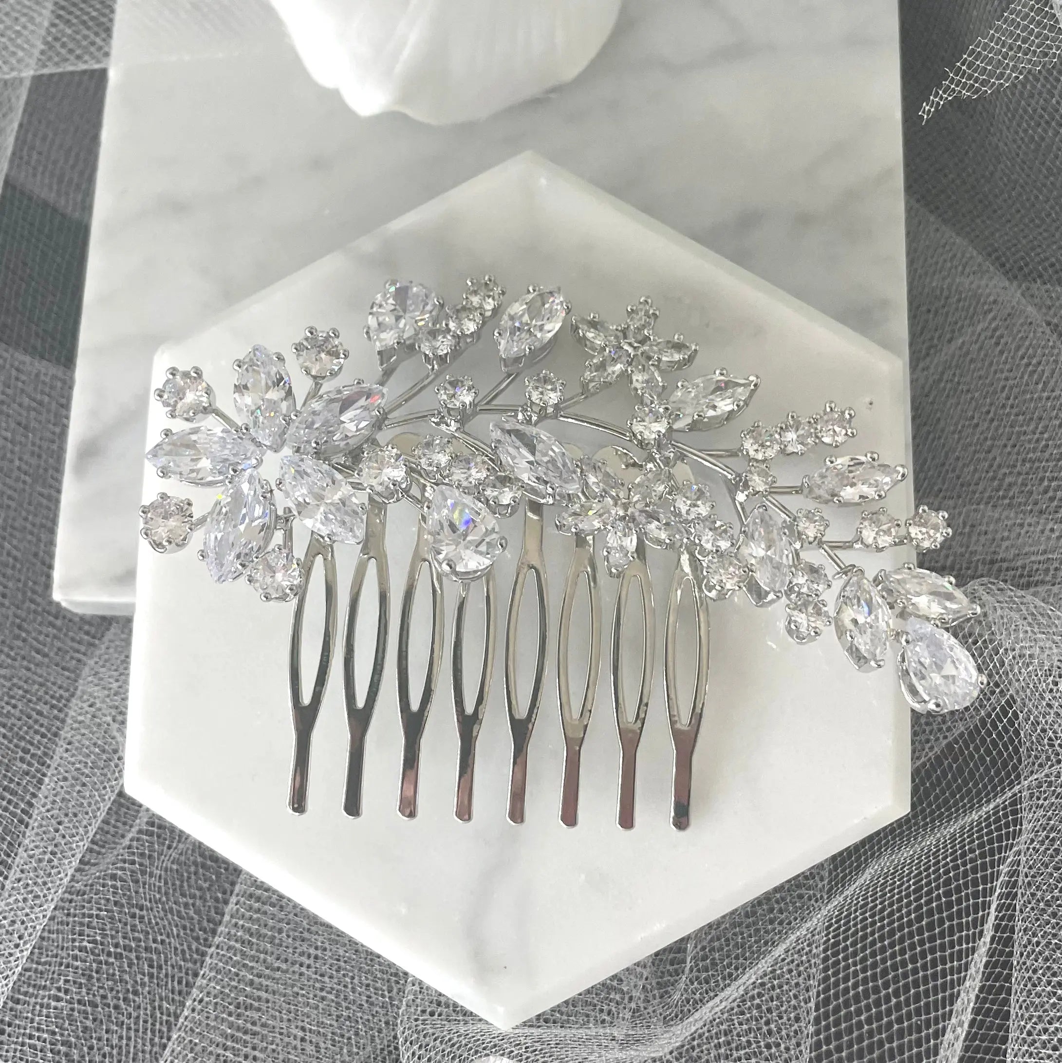 Exquisite Sally Bridal Wedding Hair Comb in silver, featuring detailed leaves, flowers, and crystal clusters, ideal for adding a sophisticated sparkle to bridal hairstyles.