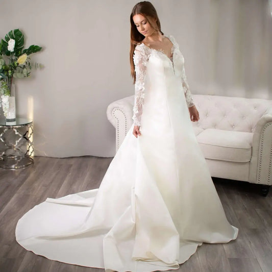 Bride in a Samantha 3D lace sleeve wedding dress with a long train.