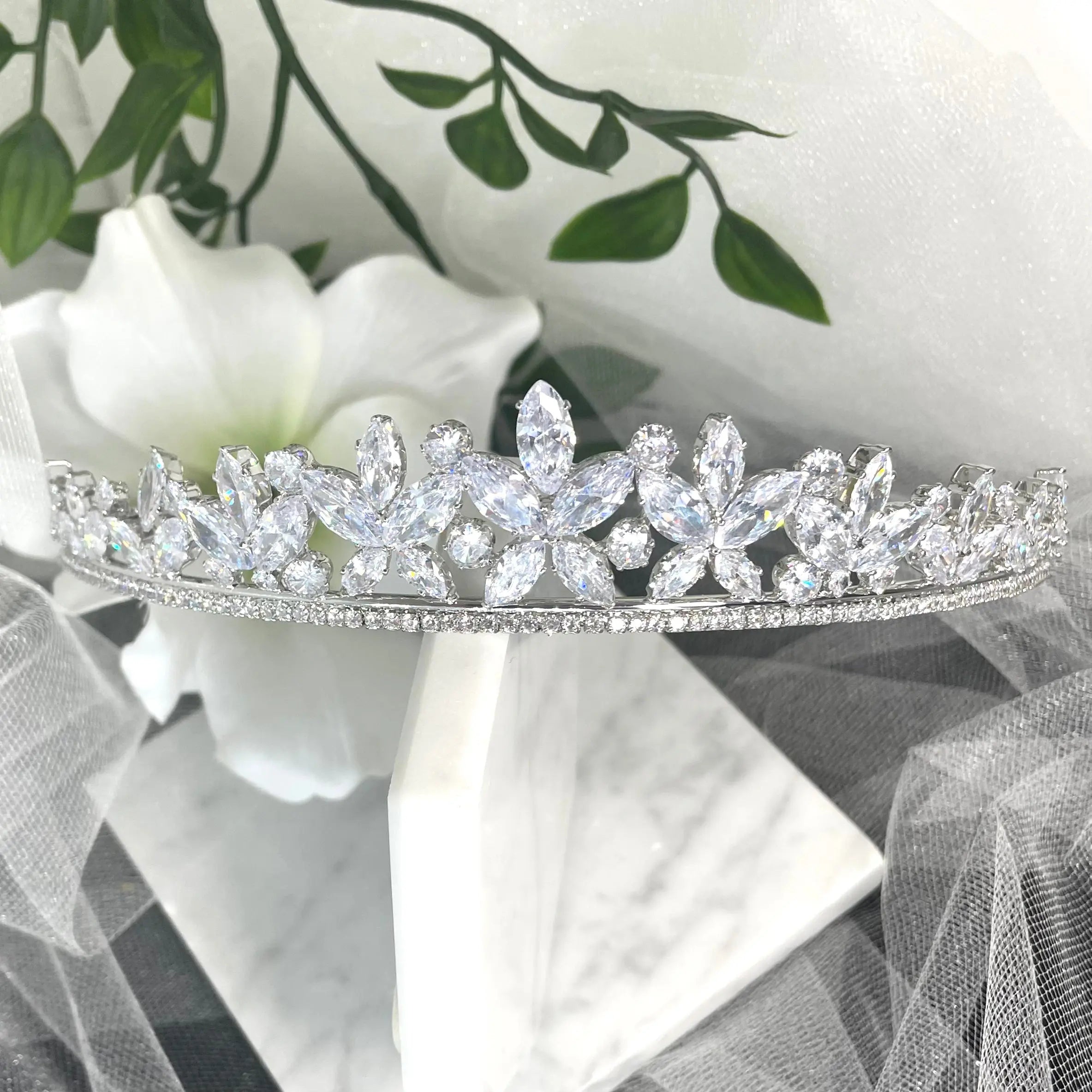 Sia Crystal Bridal Wedding Tiara in Silver, featuring sparkling cubic zirconia, floral motifs, and leaf-like crystals, designed to add a touch of elegance and luxury to any bridal look.