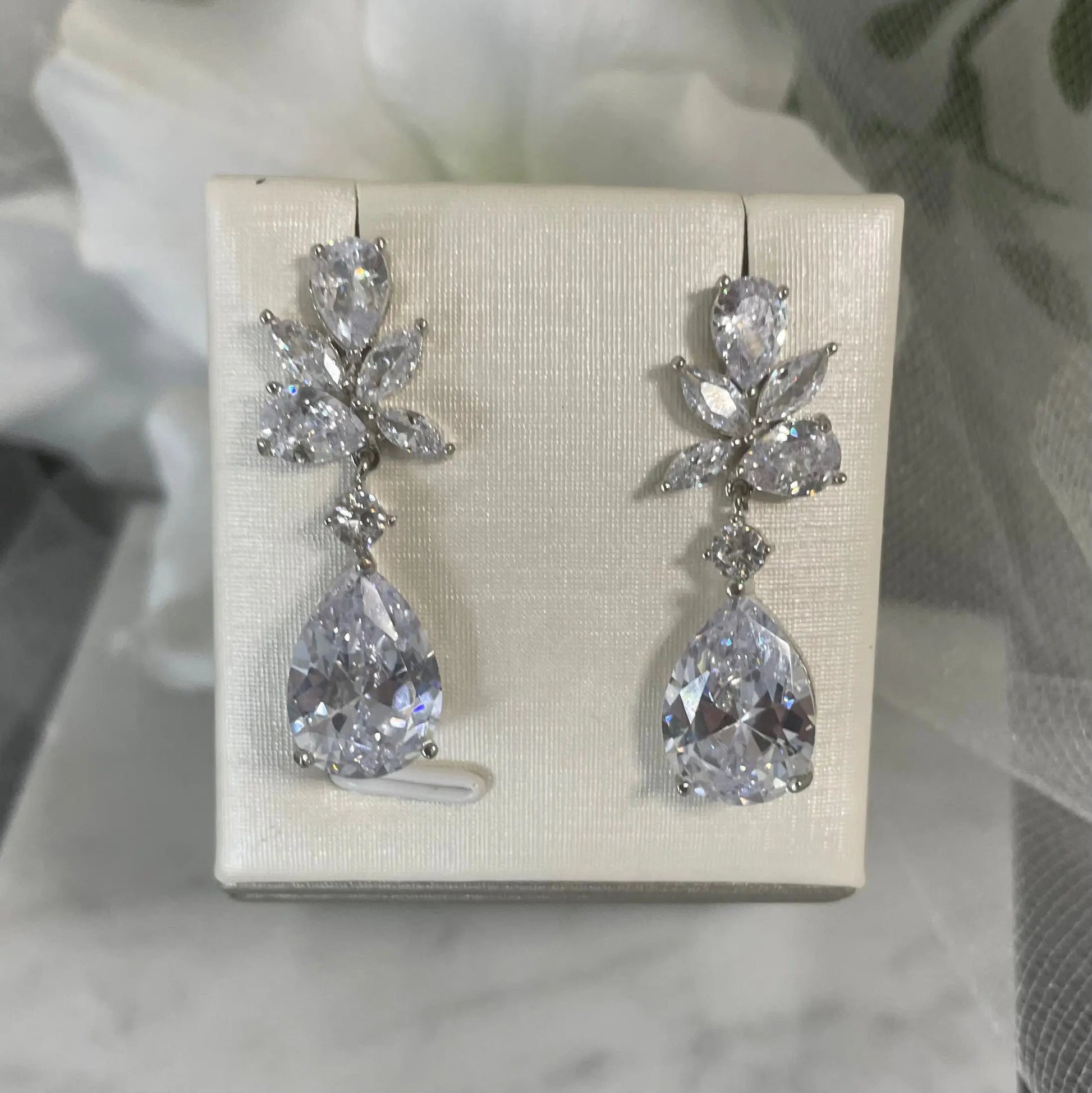 Tegan teardrop crystal earrings with a unique scattered crystal design in rhodium-plated metal, ideal for brides and bridesmaids seeking elegant and distinctive bridal jewelry.