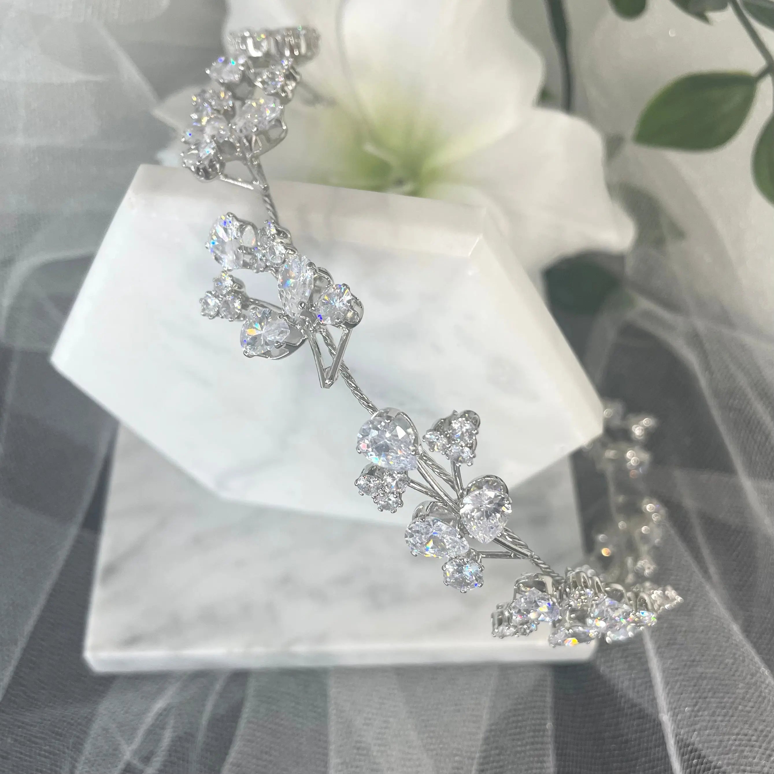 Stunning Teia Bridal Wedding Hairband with handmade silver leaves and twinkling solitaire crystals, perfect for adding a sophisticated floral touch to bridal hairstyles.