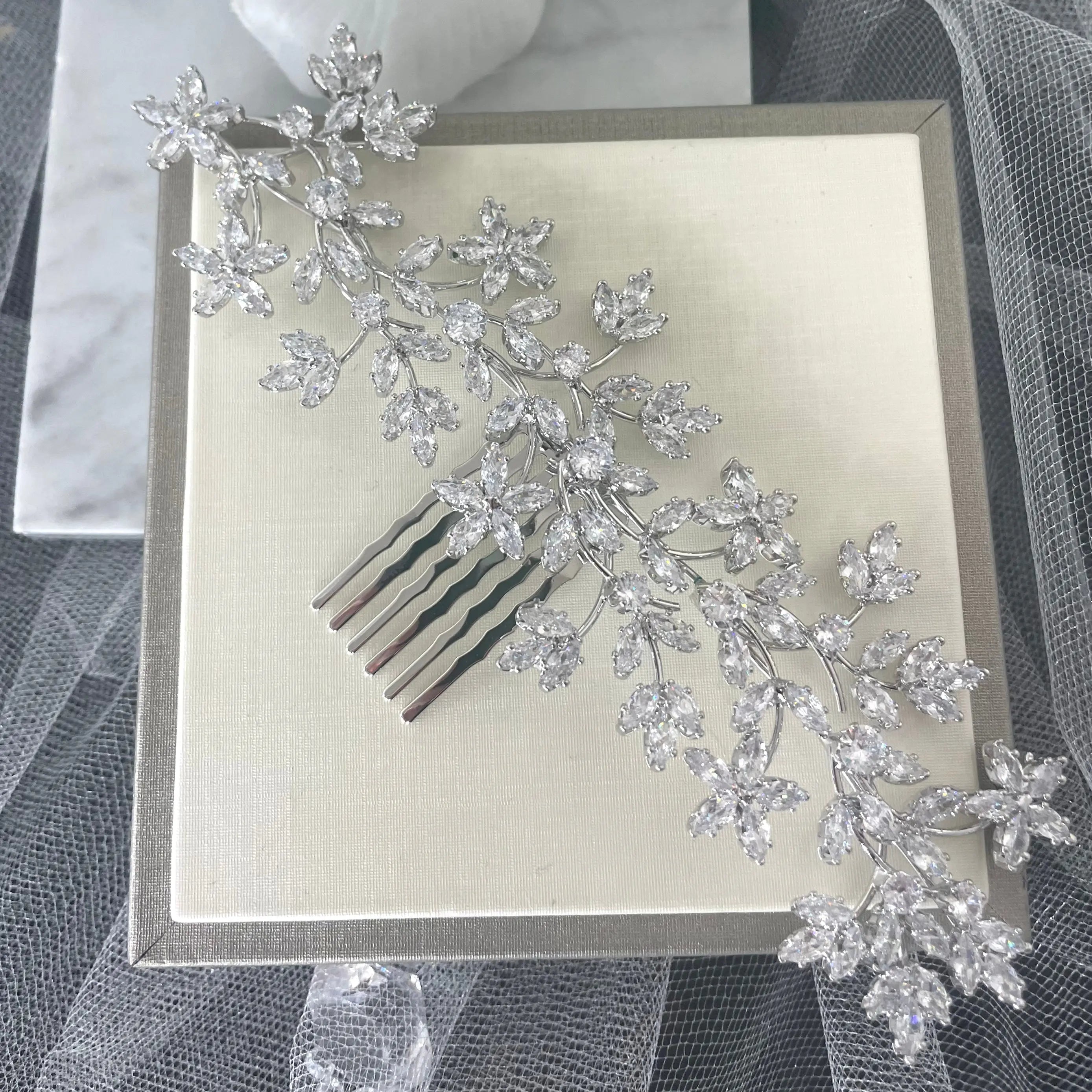 Stunning Thea Rhinestone Leaf Bridal Hair Comb in silver, featuring delicate leaf and floral vine designs adorned with sparkling crystals, perfect for enhancing bridal hairstyles.