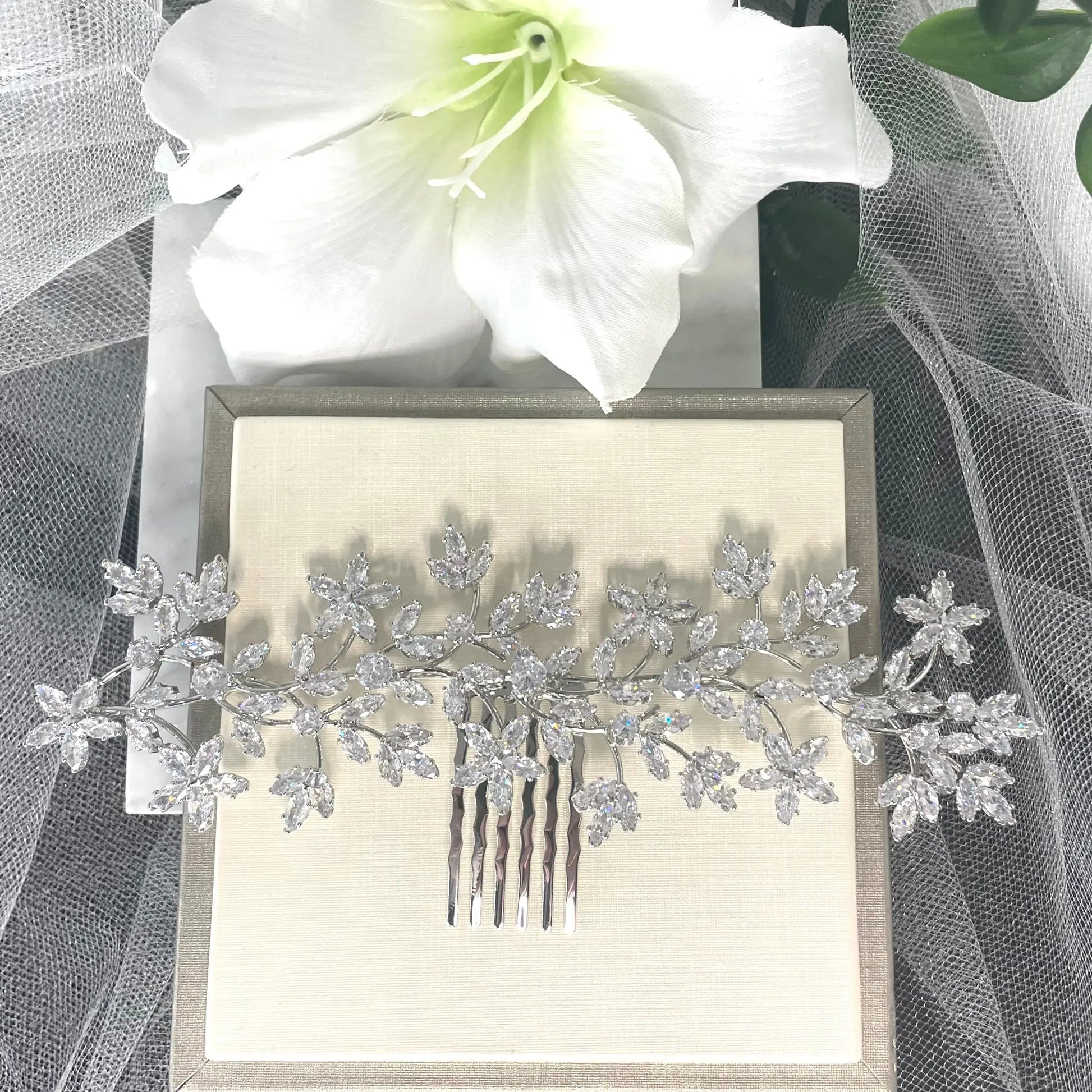 Stunning Thea Rhinestone Leaf Bridal Hair Comb in silver, featuring delicate leaf and floral vine designs adorned with sparkling crystals, perfect for enhancing bridal hairstyles.