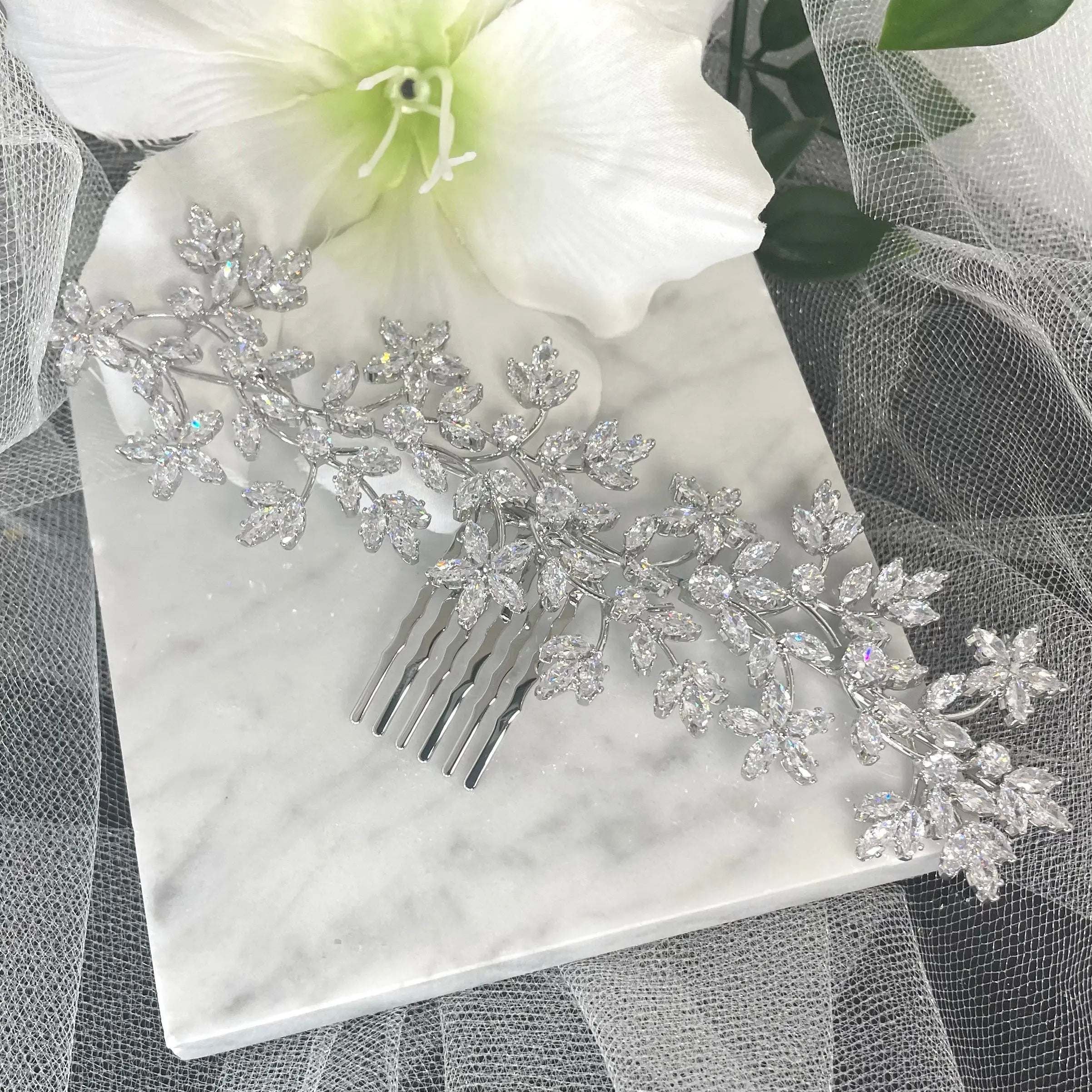 Stunning Thea Rhinestone Leaf Bridal Hair Comb in silver, featuring delicate leaf and floral vine designs adorned with sparkling crystals, perfect for enhancing bridal hairstyles.