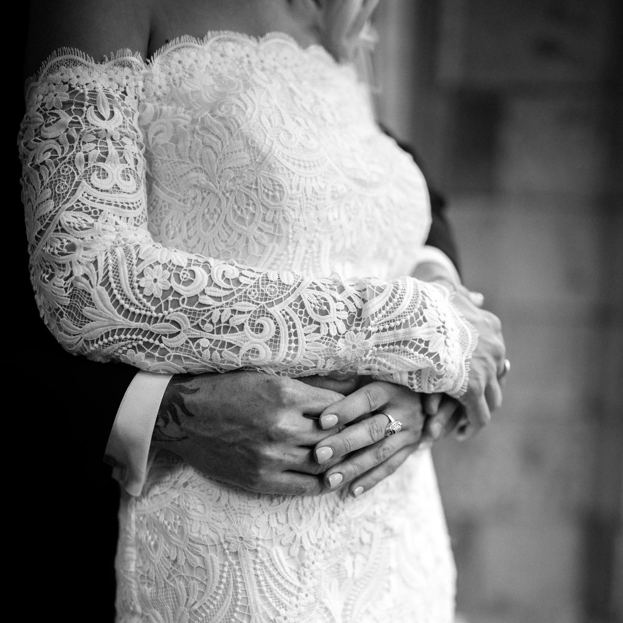 Stunning bride in the Celaya wedding dress featuring off-the-shoulder sleeves, scalloped trim, and a gracefully trailing chapel train.