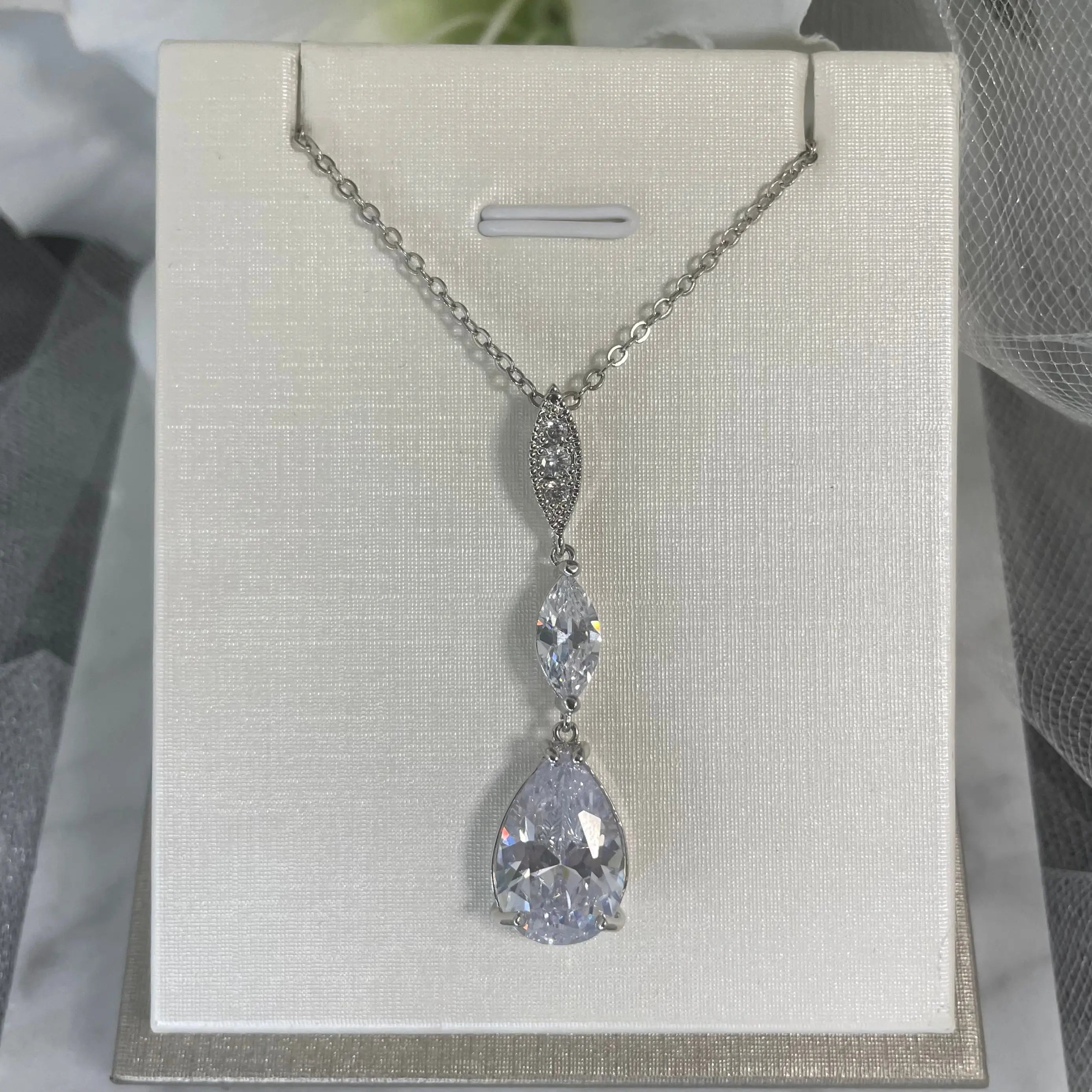 Willow Necklace: A stunning silver necklace featuring a large teardrop CZ crystal pendant, perfect for adding a touch of glamour to any outfit.