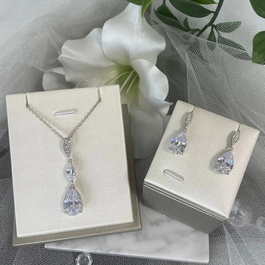 Willow Necklace & Earring Set (Silver): A glamorous silver necklace and earring set featuring large teardrop CZ crystals, perfect for weddings and formal occasions.