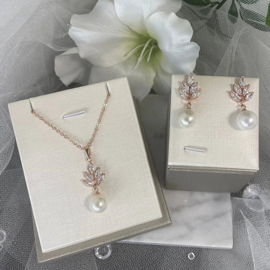 Necklace and Earrings in Rose Gold: A beautiful necklace and earrings set in rose gold, featuring leaf designs and teardrop pearls.