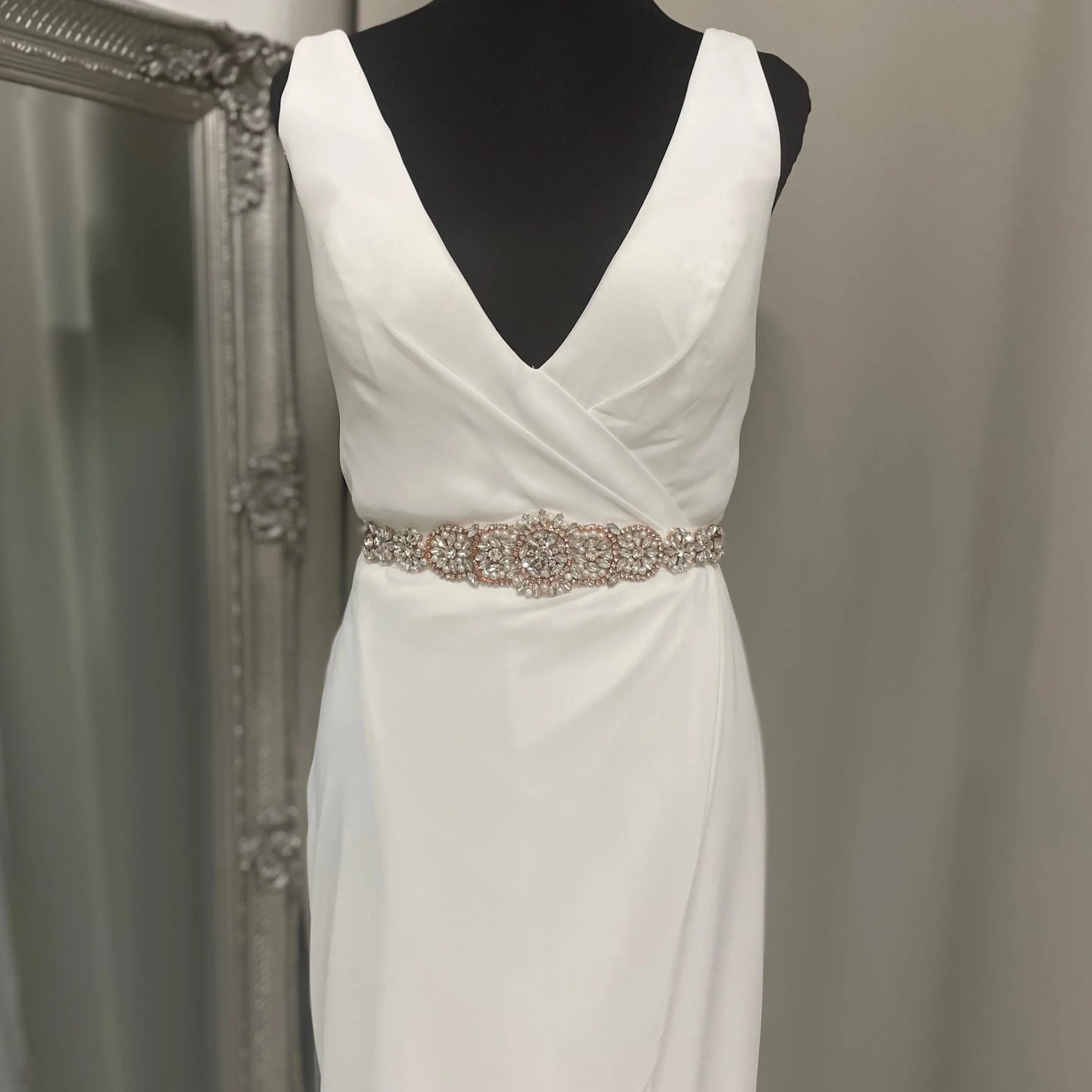 Zarah Bridal Belt displayed on a mannequin, featuring intricate detailing with pearls and diamantés, enhancing the look of a wedding gown with its sophisticated design.