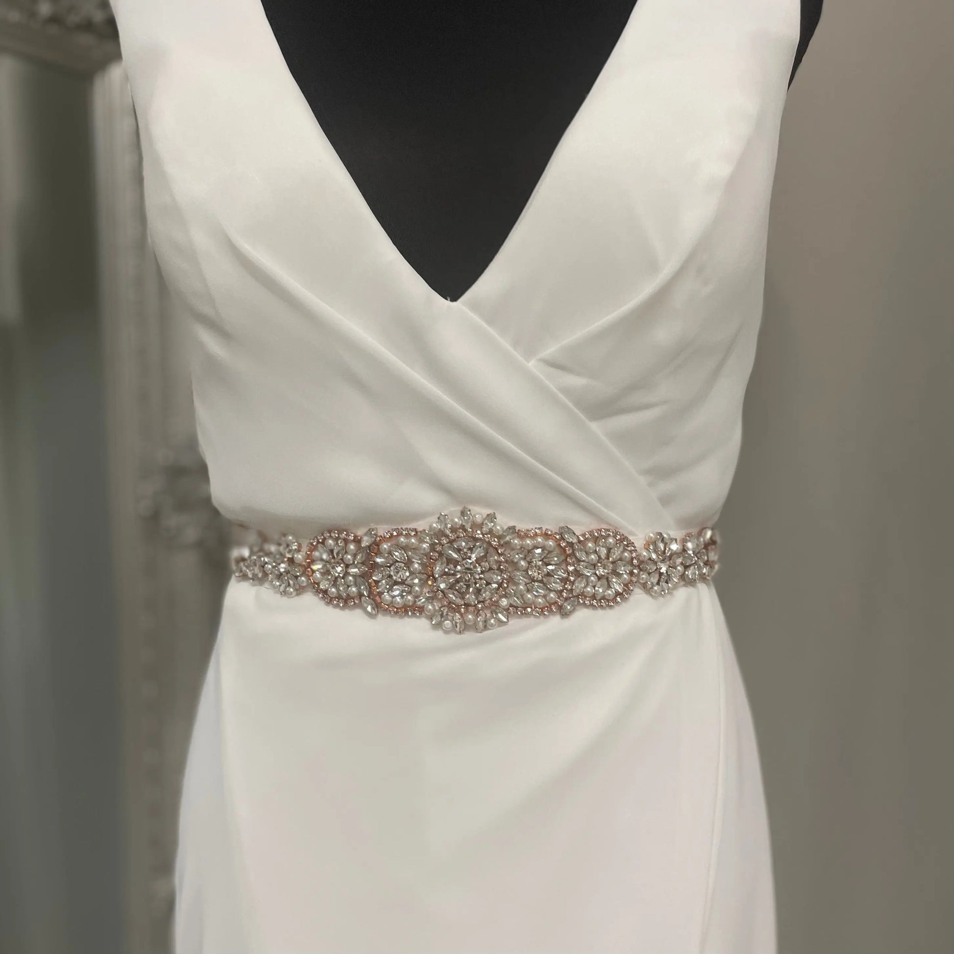 Close-up of the Zarah Bridal Belt, adorned with beautiful diamantés and pearls on a Rosegold backing, perfect for adding elegance to any wedding dress.