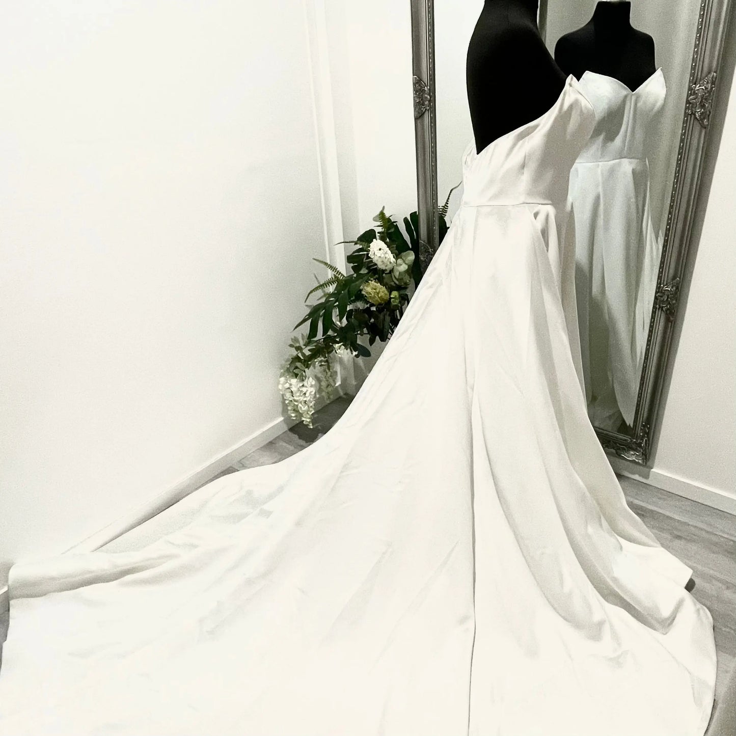 Strapless Katrin wedding gown with an A-line cut, front left split, and flowing chapel train.