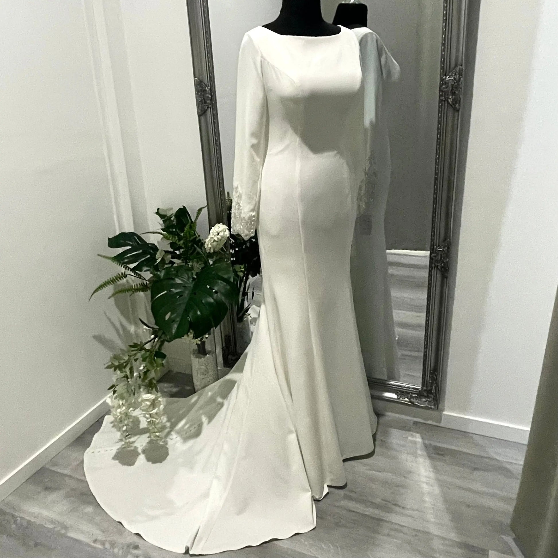 Side front view of the Krysta wedding gown, featuring the illusion bodice and lace appliqué, capturing the essence of classic bridal styles and timeless elegance.