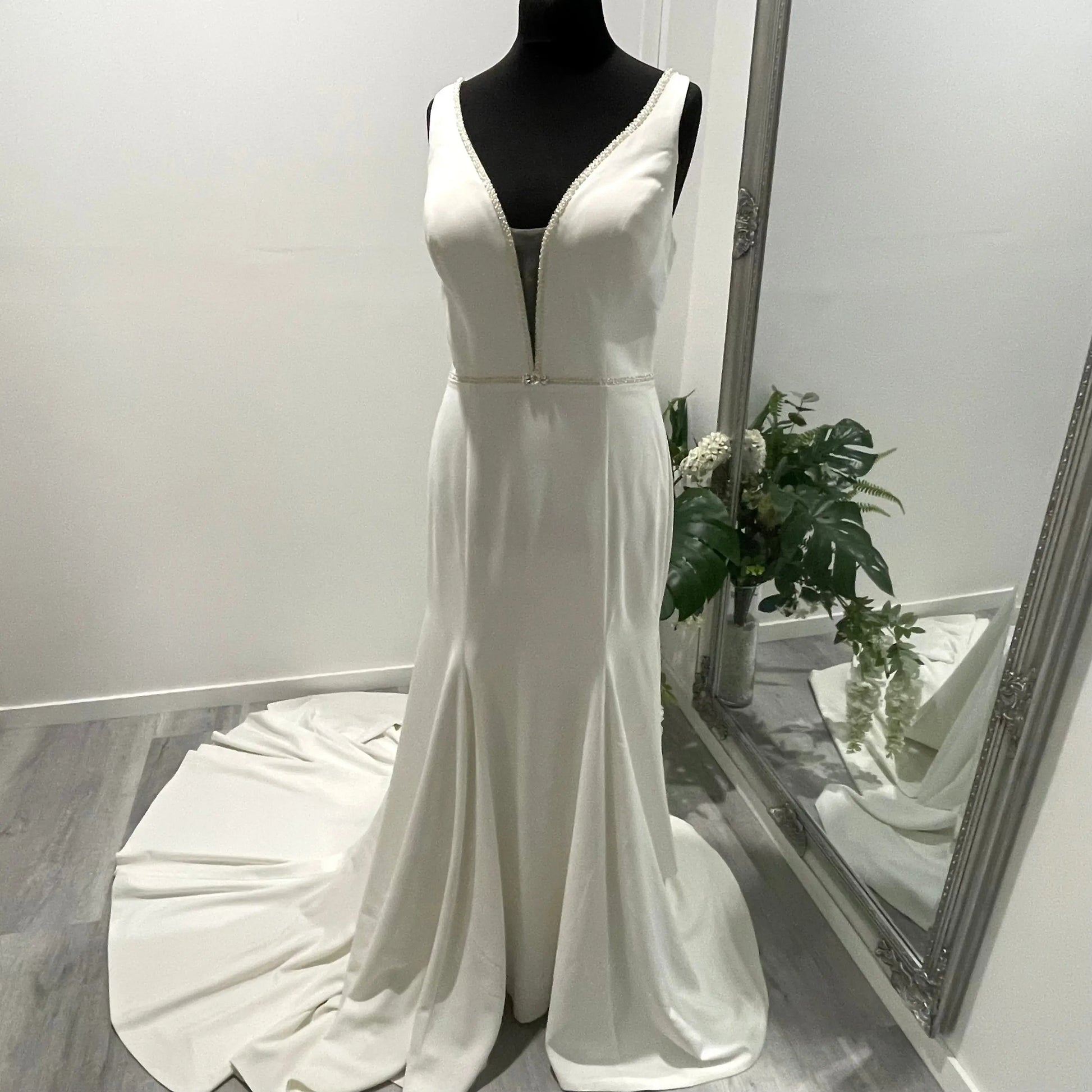 Mannequin wearing the Odette wedding gown by The Bride Company, highlighting the dress's flattering V neckline and fit and flare style.