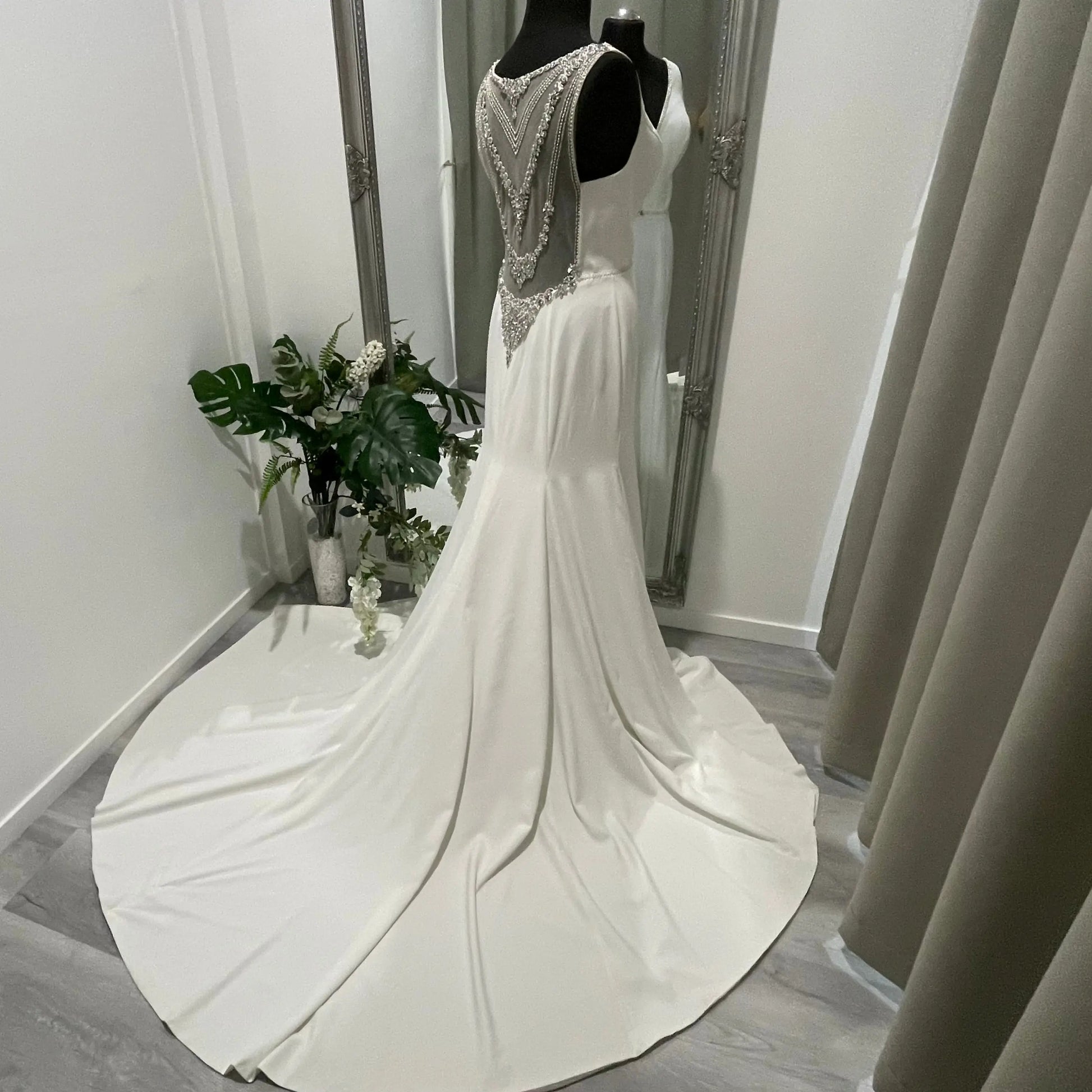 The Odette wedding gown by The Bride Company, featuring a fit and flare style that accentuates the curves of the body, creating a stunning silhouette.